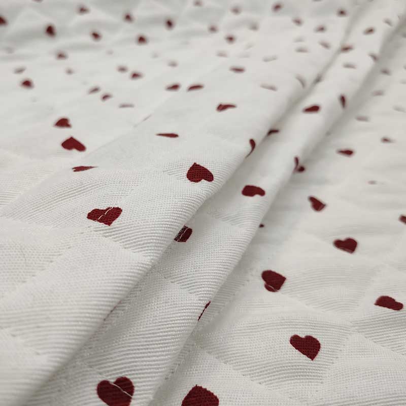 Tessuto trauntato cotone cuori rossi sfondo bianco