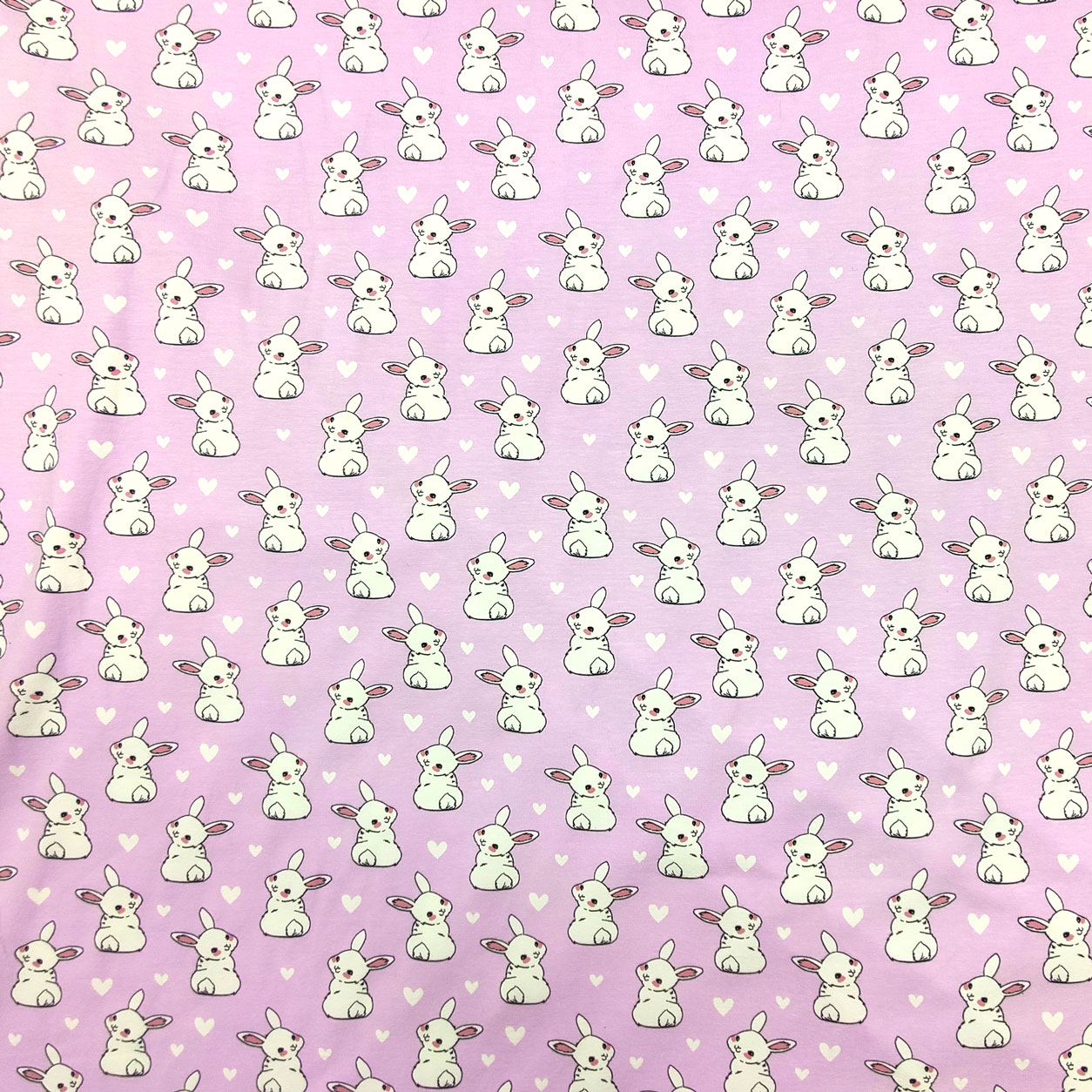 tessuto-maglina-in-cotone-coniglietti-sfondo-rosa-chiaro