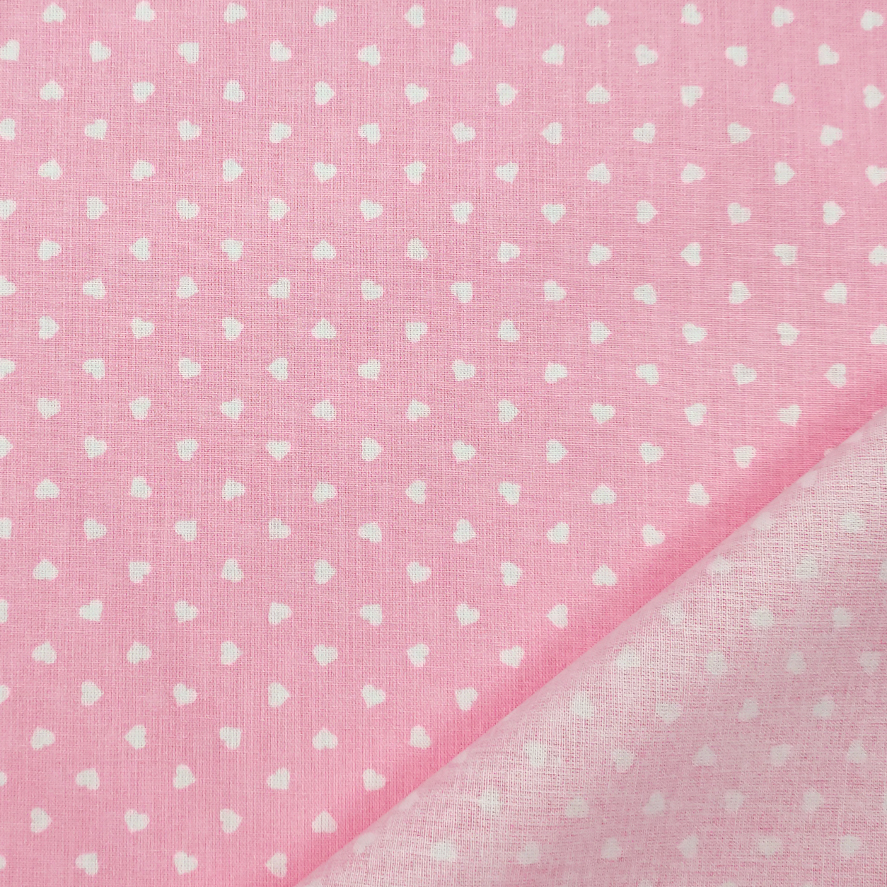 Tessuto cotone òeggero percallino cuori bianchi sfondo rosa