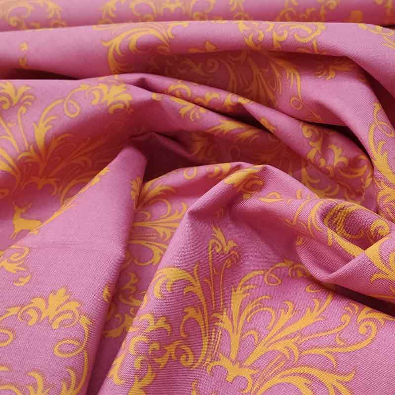 Tessuto in cotone rosa con fantasia arancione