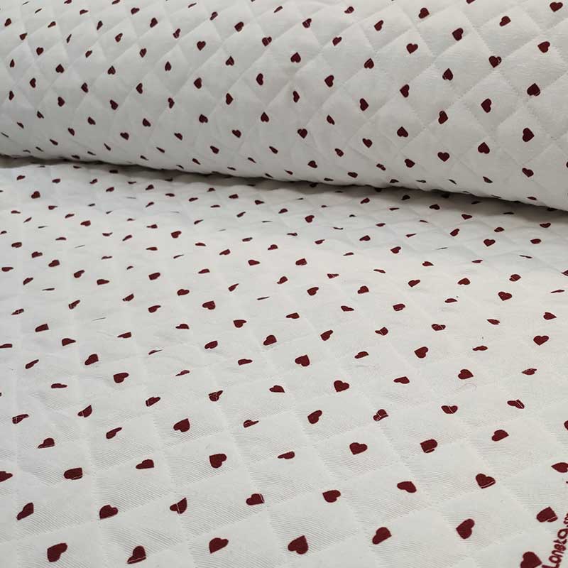 Tessuto trapunato al metro cuori rossi sfondo bianco
