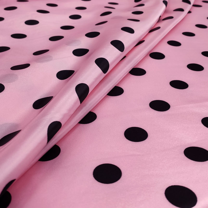 Tessuto per vestiti di carnevale pois neri sfondo rosa