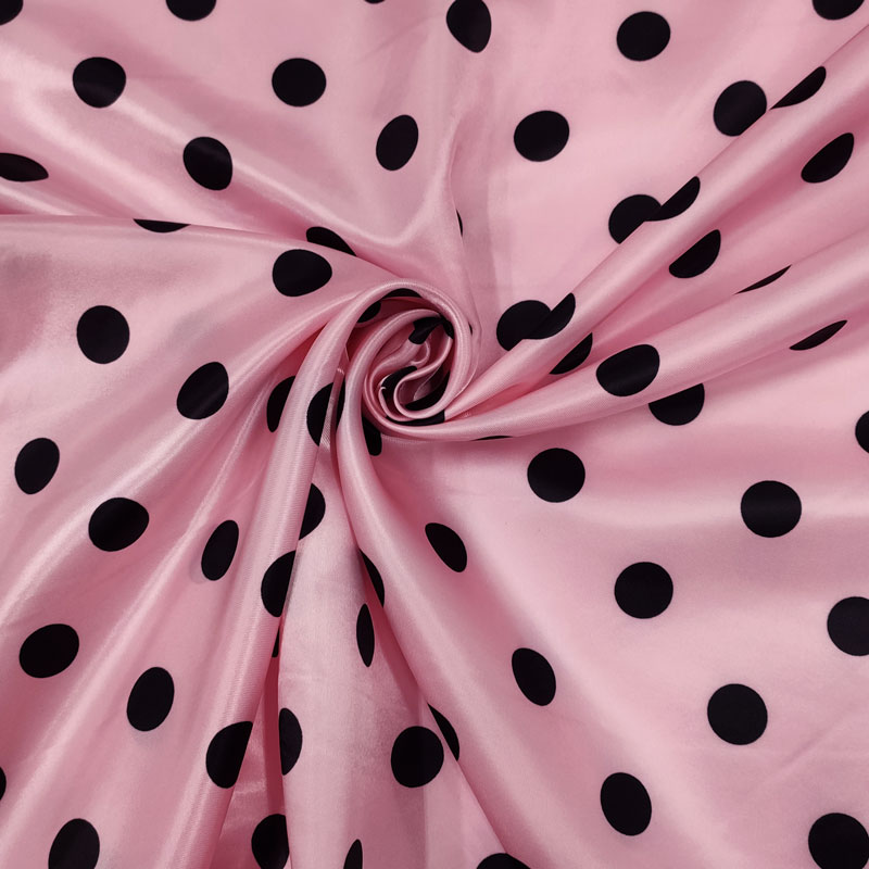 Tessuto fantasia carnevale pois neri sfondo rosa