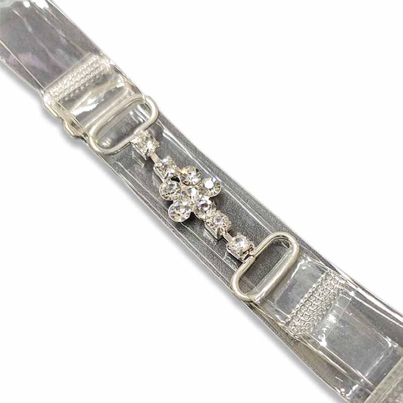 Dettaglio spallina trasparente con strass e fiorellino