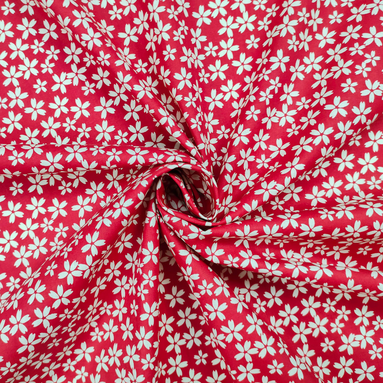 stoffa in cotone fiore panna rosso