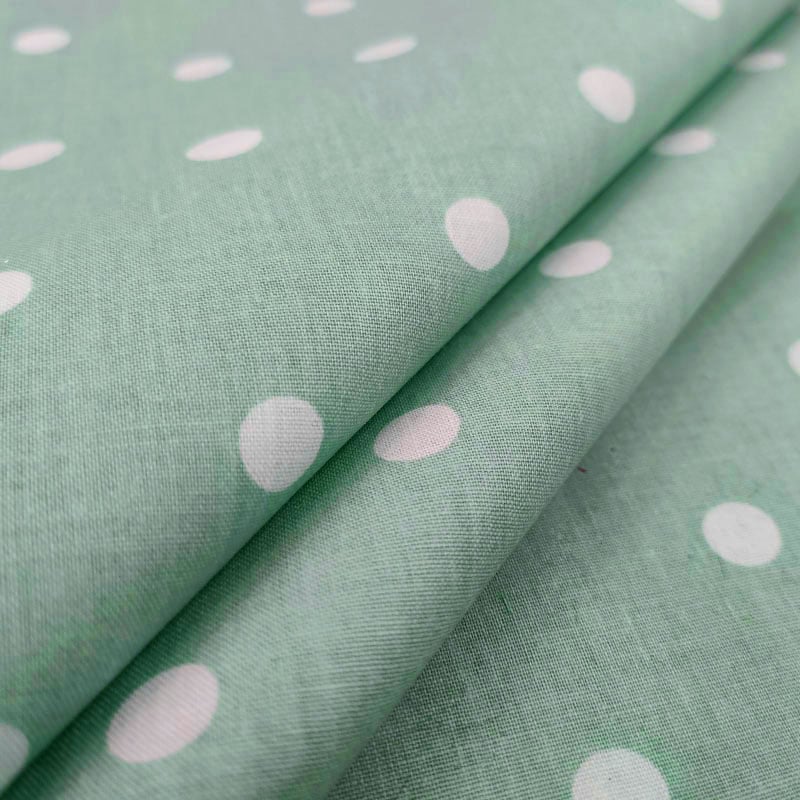 Tessuto di cotone verde pois bianchi